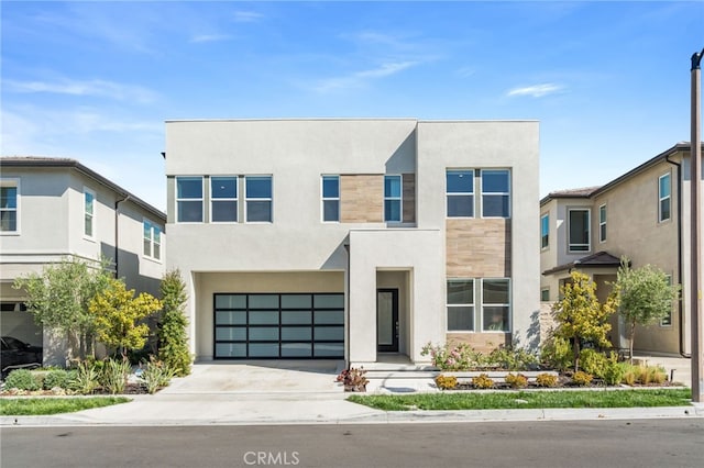 211 Wild Flower, Lake Forest, CA 92630 - view of front of home with stucco siding, a garage, and concrete driveway