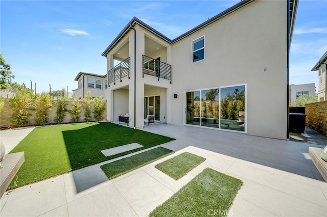 211 Wild Flower, Lake Forest, CA 92630 - back of property with a balcony, stucco siding, a patio, and a fenced backyard