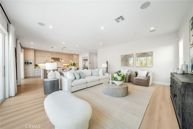 211 Wild Flower, Lake Forest, CA 92630 - living room featuring light wood-style flooring and recessed lighting