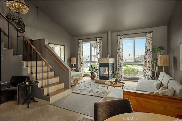 837 N W Knoll Dr Unit 307, West Hollywood, CA 90069 - living room featuring lofted ceiling, stairs, and a multi sided fireplace