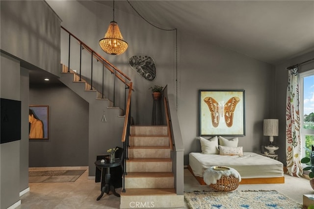 837 N W Knoll Dr Unit 307, West Hollywood, CA 90069 - staircase with a chandelier and high vaulted ceiling