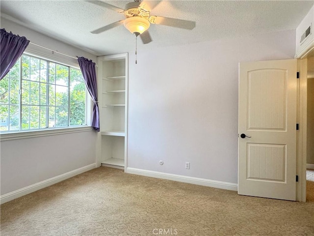 2817 San Verbena Way, Chico, CA 95973 - carpeted empty room with a textured ceiling, ceiling fan, and built in shelves