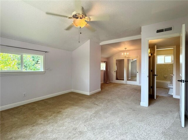 2817 San Verbena Way, Chico, CA 95973 - empty room featuring lofted ceiling, light colored carpet, a chandelier, a textured ceiling, and ceiling fan
