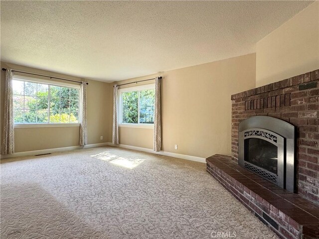 2817 San Verbena Way, Chico, CA 95973 - unfurnished living room featuring carpet flooring, a fireplace, and a textured ceiling