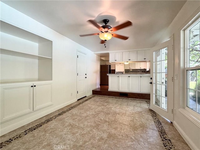 2817 San Verbena Way, Chico, CA 95973 - kitchen with ceiling fan, freestanding refrigerator, a peninsula, and white cabinets