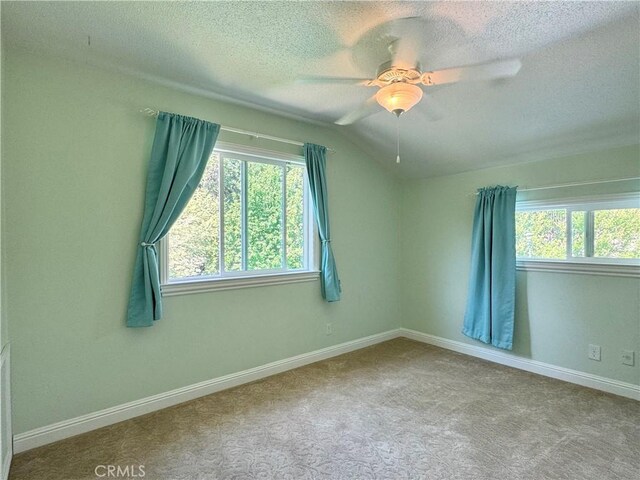 2817 San Verbena Way, Chico, CA 95973 - spare room with a textured ceiling, vaulted ceiling, a ceiling fan, and carpet flooring