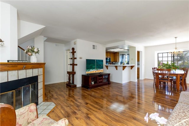 854 N Harbor Blvd, La Habra, CA 90631 - living area featuring wood finished floors, a chandelier, and a fireplace