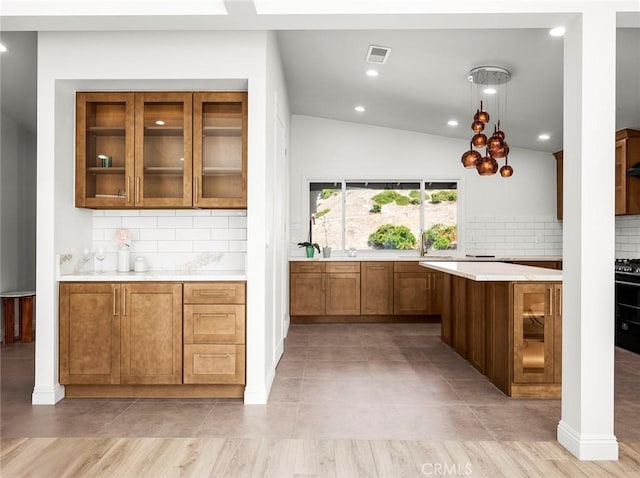 11410 Reseda Blvd, Porter Ranch, CA 91326 - kitchen with brown cabinets, light countertops, decorative backsplash, glass insert cabinets, and recessed lighting