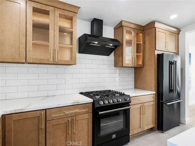11410 Reseda Blvd, Porter Ranch, CA 91326 - kitchen with wall chimney exhaust hood, black gas range, high quality fridge, light stone counters, and glass insert cabinets