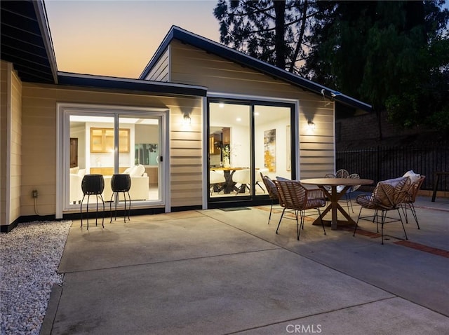 11410 Reseda Blvd, Porter Ranch, CA 91326 - back of property at dusk with a patio and outdoor dining area