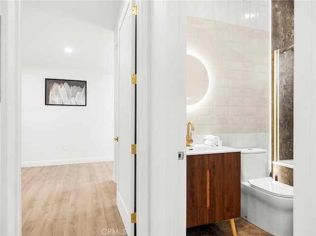 11410 Reseda Blvd, Porter Ranch, CA 91326 - full bathroom featuring vanity, wood finished floors, a shower with door, and tile walls