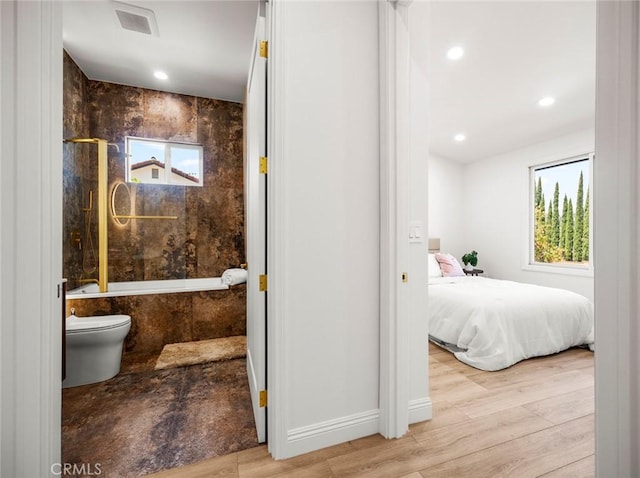 11410 Reseda Blvd, Porter Ranch, CA 91326 - ensuite bathroom featuring wood finished floors, tiled shower / bath combo, and recessed lighting