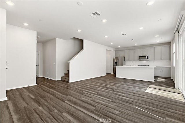 36390 W Flare, Winchester, CA 92569 - unfurnished living room featuring dark wood finished floors, stairs, and recessed lighting