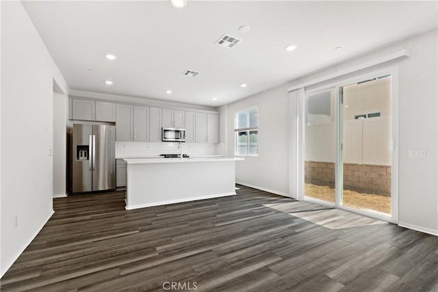 36390 W Flare, Winchester, CA 92569 - kitchen featuring stainless steel appliances, dark wood finished floors, an island with sink, light countertops, and recessed lighting