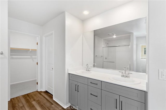 36390 W Flare, Winchester, CA 92569 - bathroom with a stall shower, wood finished floors, a walk in closet, and double vanity