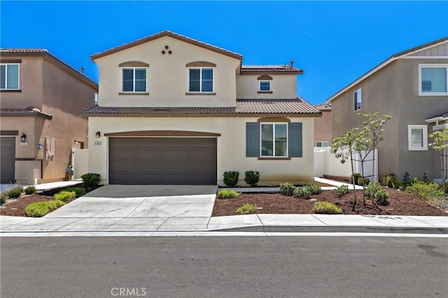 36390 W Flare, Winchester, CA 92569 - mediterranean / spanish-style home with stucco siding, concrete driveway, roof mounted solar panels, a tile roof, and an attached garage