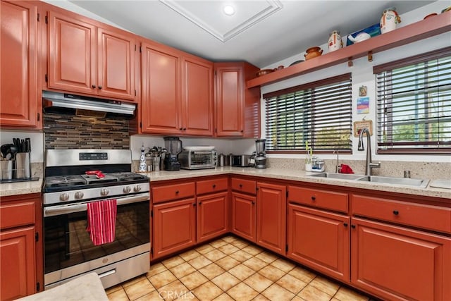 10422 Patricia Dr, Garden Grove, CA 92840 - kitchen with stainless steel range with gas stovetop, under cabinet range hood, light countertops, and light tile patterned floors
