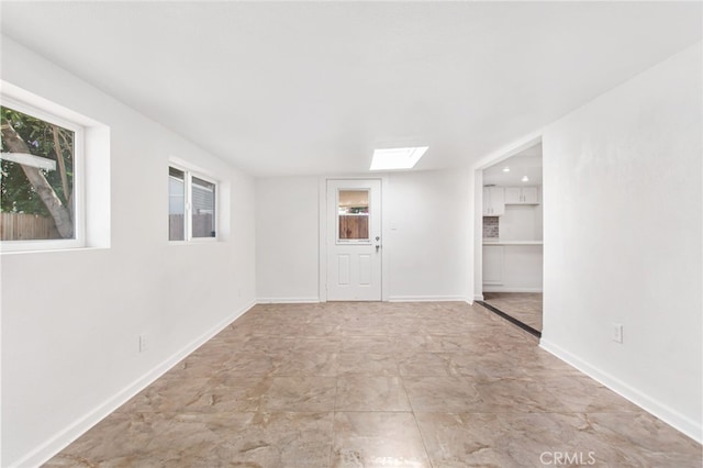 4215 Sherman Dr, Riverside, CA 92503 - spare room featuring a skylight and baseboards