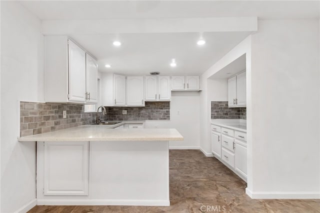 4215 Sherman Dr, Riverside, CA 92503 - kitchen with a peninsula, white cabinetry, tasteful backsplash, light countertops, and recessed lighting