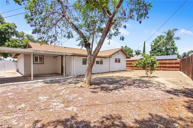 4215 Sherman Dr, Riverside, CA 92503 - back of property featuring a fenced backyard, stucco siding, and a patio