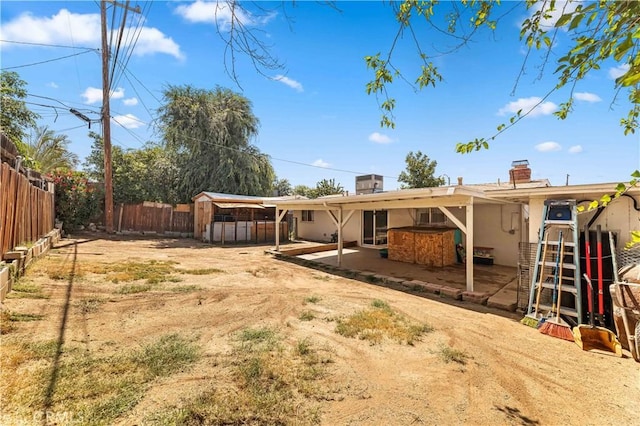 26920 14th St, Highland, CA 92346 - back of house featuring a fenced backyard, stucco siding, a patio area, a chimney, and a storage shed