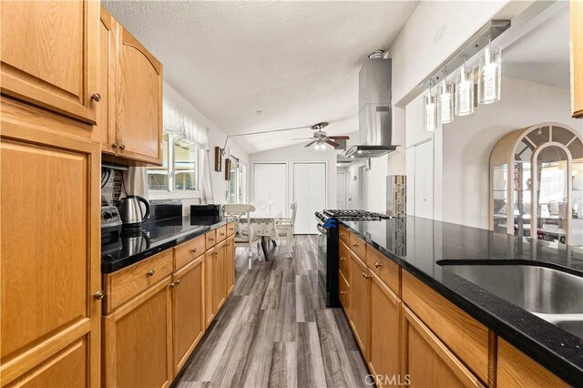26920 14th St, Highland, CA 92346 - kitchen featuring range with gas cooktop, dark wood-style floors, ceiling fan, extractor fan, and dark stone counters