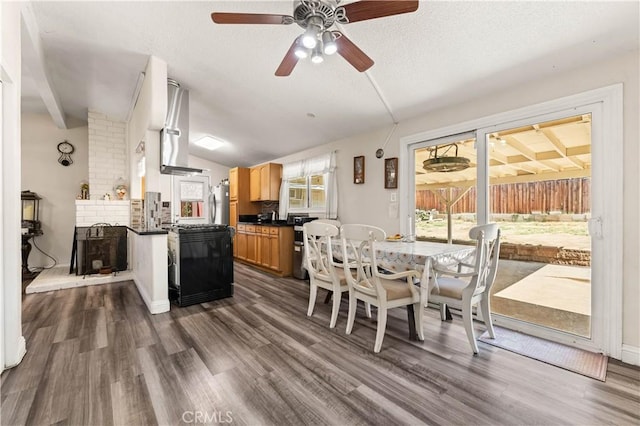 26920 14th St, Highland, CA 92346 - dining room featuring vaulted ceiling, a ceiling fan, dark wood-type flooring, and a textured ceiling