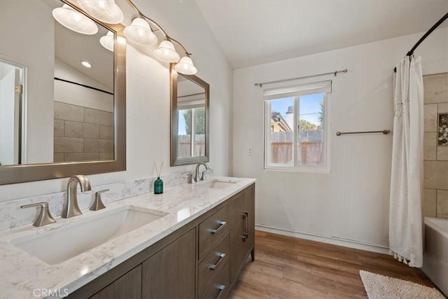 1288 Capitola St, Grover Beach, CA 93433 - bathroom featuring lofted ceiling, double vanity, wood finished floors, and shower / bath combo
