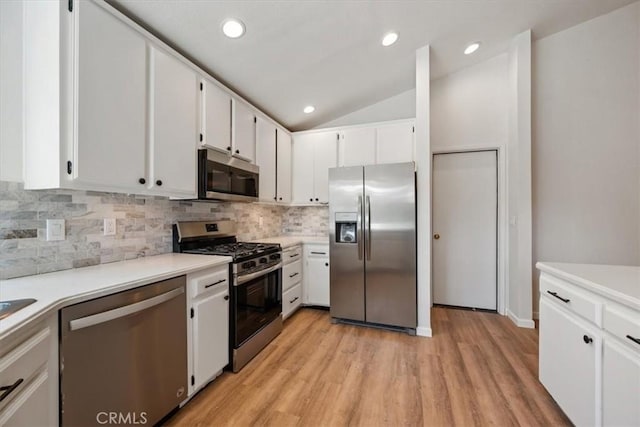 1288 Capitola St, Grover Beach, CA 93433 - kitchen with stainless steel appliances, backsplash, light countertops, light wood-style flooring, and vaulted ceiling