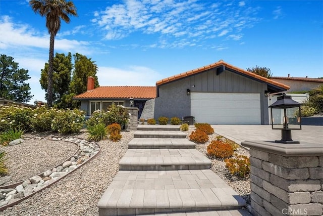 28639 Quaint St, Agoura Hills, CA 91301 - ranch-style house with a tile roof, an attached garage, a chimney, and concrete driveway