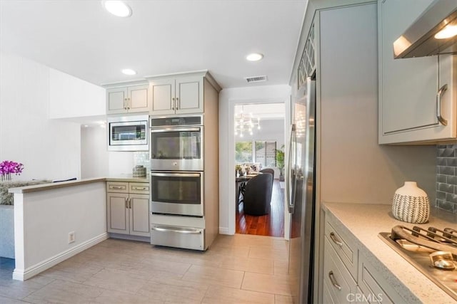 28639 Quaint St, Agoura Hills, CA 91301 - kitchen with stainless steel appliances, a warming drawer, wall chimney range hood, decorative backsplash, and recessed lighting