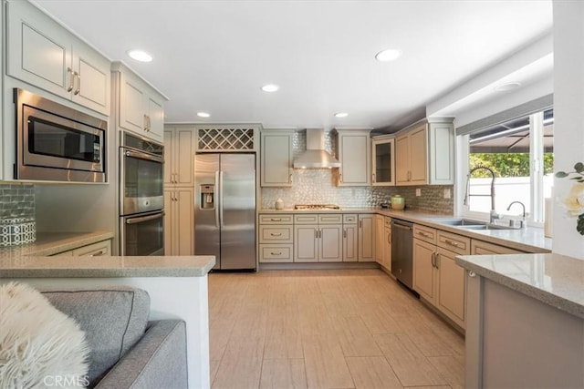 28639 Quaint St, Agoura Hills, CA 91301 - kitchen featuring appliances with stainless steel finishes, wall chimney exhaust hood, backsplash, light wood finished floors, and recessed lighting