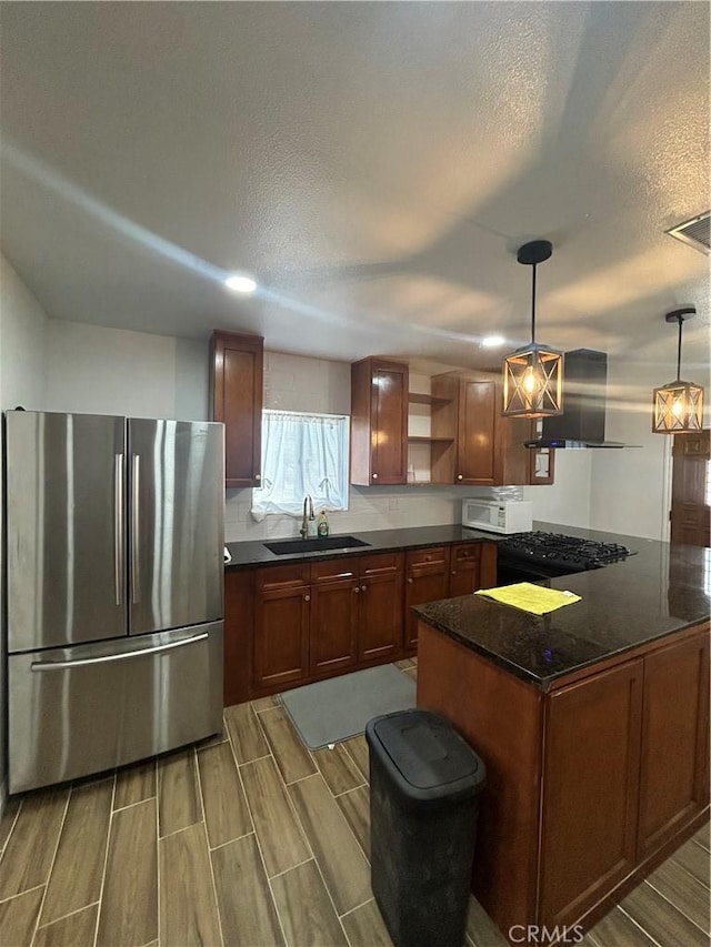 35862 Rabbit Spring Rd, Lucerne Valley, CA 92356 - kitchen featuring freestanding refrigerator, white microwave, wall chimney exhaust hood, a textured ceiling, and open shelves