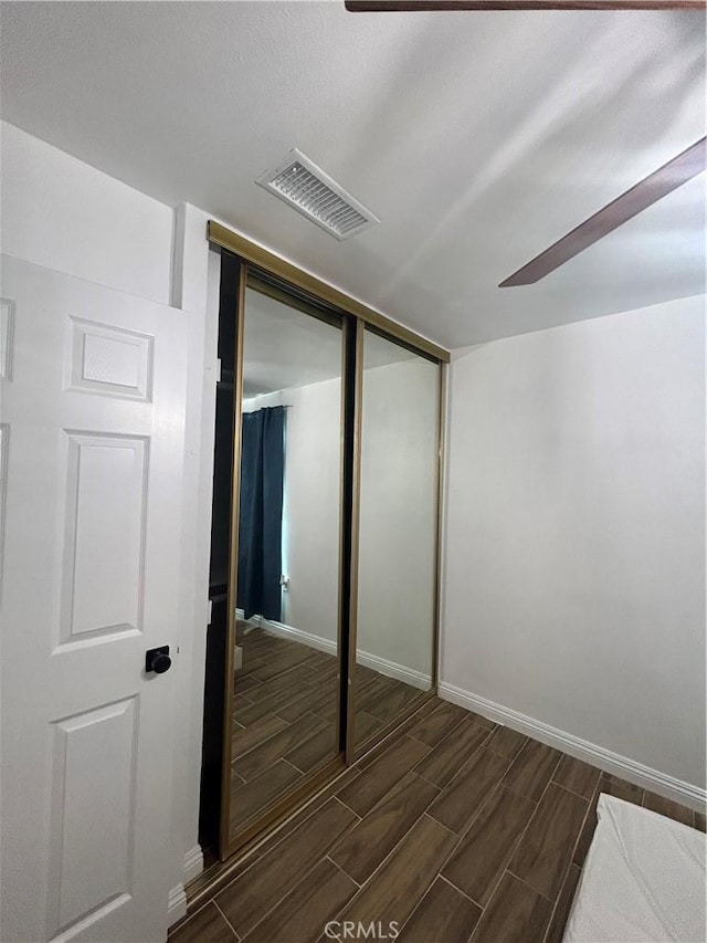 35862 Rabbit Spring Rd, Lucerne Valley, CA 92356 - unfurnished bedroom with wood tiled floors and a closet