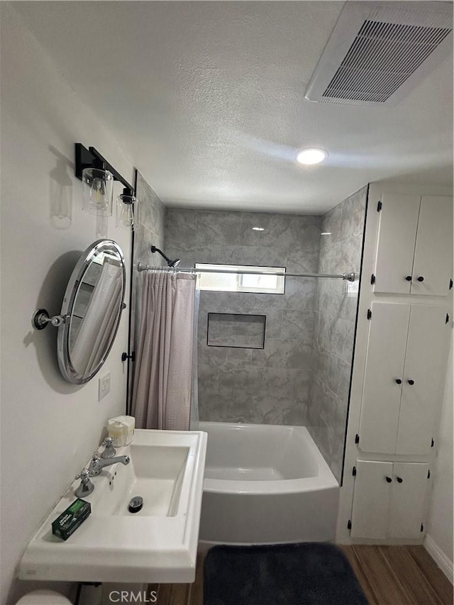 35862 Rabbit Spring Rd, Lucerne Valley, CA 92356 - bathroom with shower / tub combo with curtain, wood finished floors, and a textured ceiling