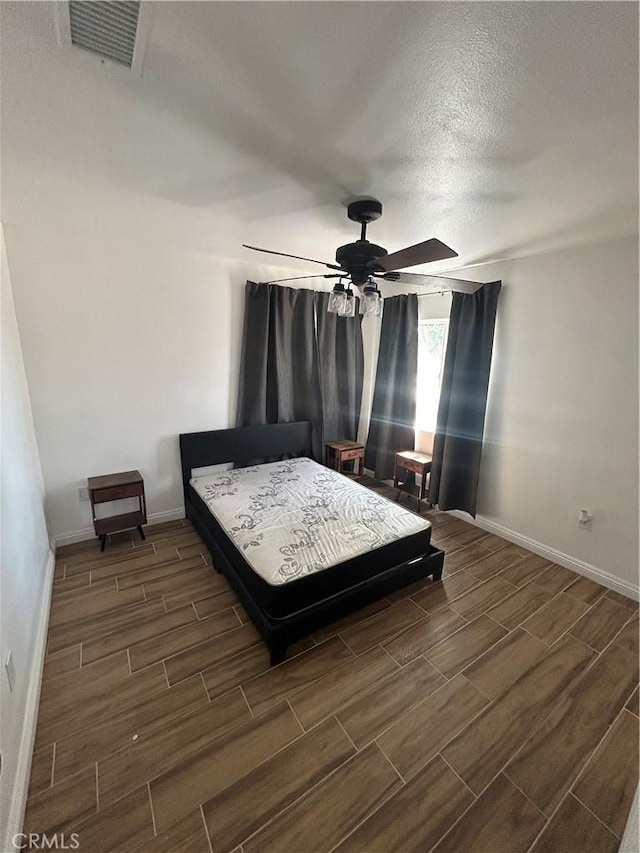 35862 Rabbit Spring Rd, Lucerne Valley, CA 92356 - bedroom with wood tiled floors, ceiling fan, and a textured ceiling