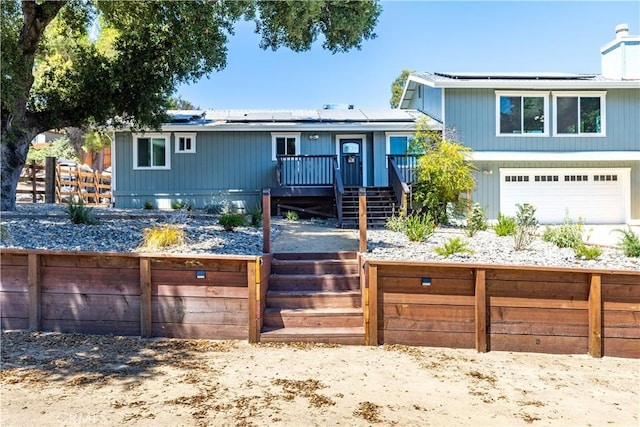 4725 Arena Ave, Atascadero, CA 93422 - view of front facade with stairway, solar panels, a deck, and a chimney