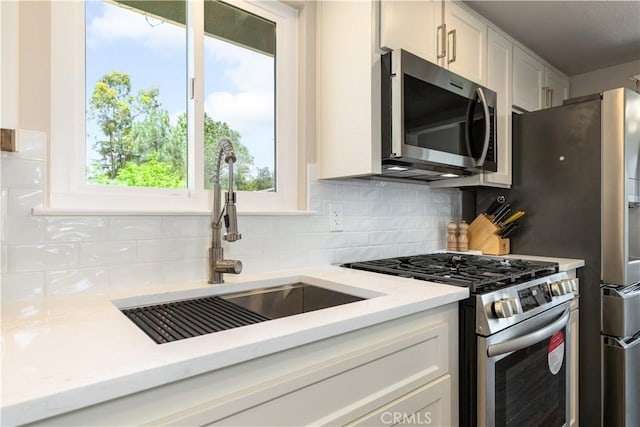 4725 Arena Ave, Atascadero, CA 93422 - kitchen with stainless steel appliances, white cabinets, and backsplash