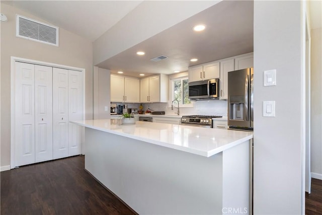 4725 Arena Ave, Atascadero, CA 93422 - kitchen with appliances with stainless steel finishes, dark wood-type flooring, light countertops, white cabinets, and recessed lighting