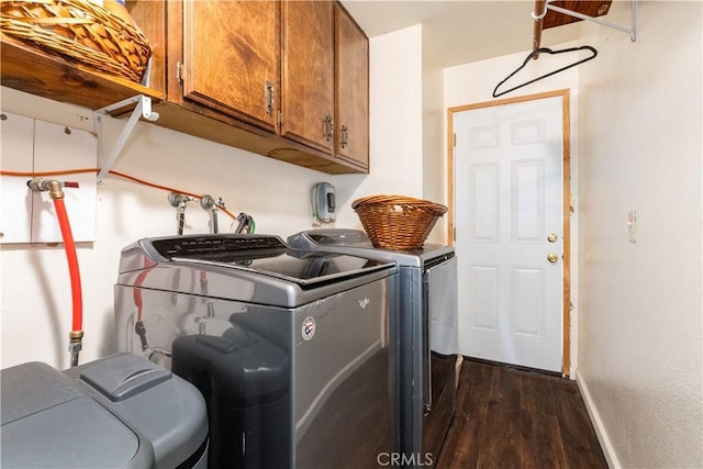 4725 Arena Ave, Atascadero, CA 93422 - washroom with cabinet space, washing machine and clothes dryer, and dark wood-style flooring