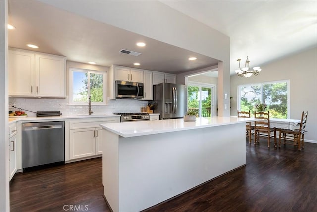 4725 Arena Ave, Atascadero, CA 93422 - kitchen featuring appliances with stainless steel finishes, healthy amount of natural light, dark wood-style floors, decorative backsplash, and recessed lighting