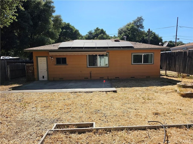 3172 16th St, Clearlake, CA 95422 - rear view of house with crawl space, a patio, a fenced backyard, and solar panels