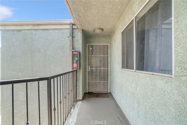 1566 Pine Ave Unit 207A, Long Beach, CA 90813 - view of exterior entry featuring stucco siding and a balcony