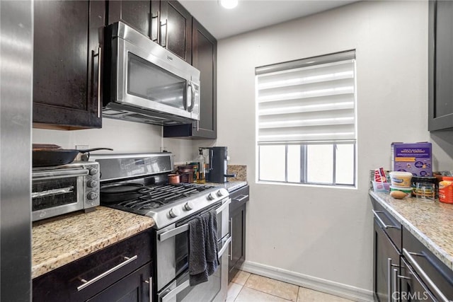 1566 Pine Ave Unit 207A, Long Beach, CA 90813 - kitchen with appliances with stainless steel finishes, light tile patterned floors, light stone countertops, dark brown cabinets, and recessed lighting