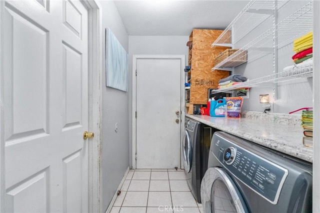 14343 Marilla Ave, Norwalk, CA 90650 - laundry area featuring washer and dryer and light tile patterned flooring