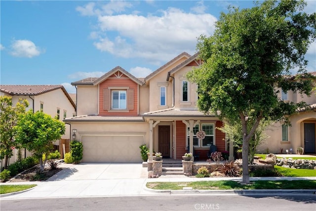 27 Cache St, Rancho Mission Viejo, CA 92694 - view of front of home featuring covered porch, a garage, stucco siding, and concrete driveway