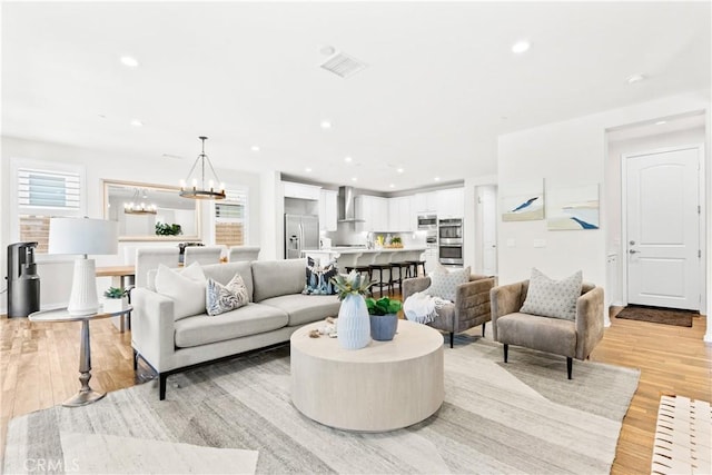 27 Cache St, Rancho Mission Viejo, CA 92694 - living area with light wood-style flooring, a chandelier, and recessed lighting