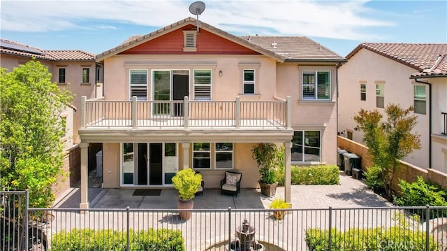27 Cache St, Rancho Mission Viejo, CA 92694 - rear view of house featuring a balcony, stucco siding, and a fenced backyard