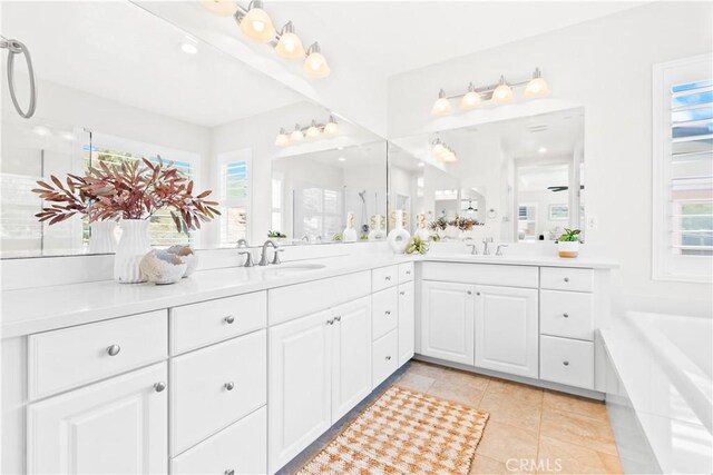 27 Cache St, Rancho Mission Viejo, CA 92694 - bathroom with double vanity, a garden tub, and tile patterned floors