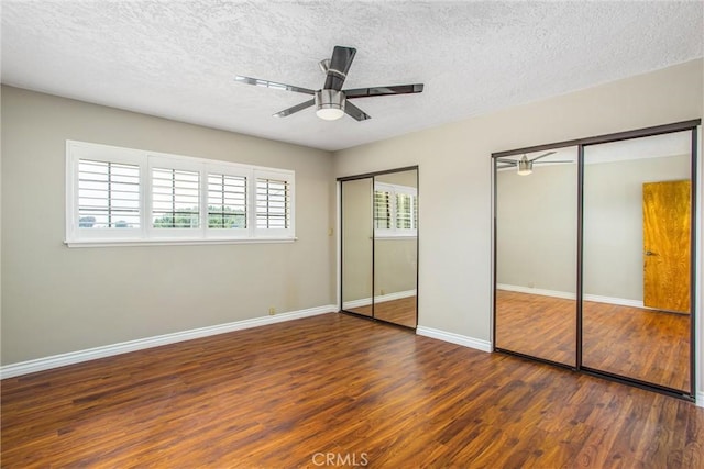 1835 Hilltop Dr, Colton, CA 92324 - unfurnished bedroom featuring two closets, wood finished floors, a textured ceiling, and a ceiling fan